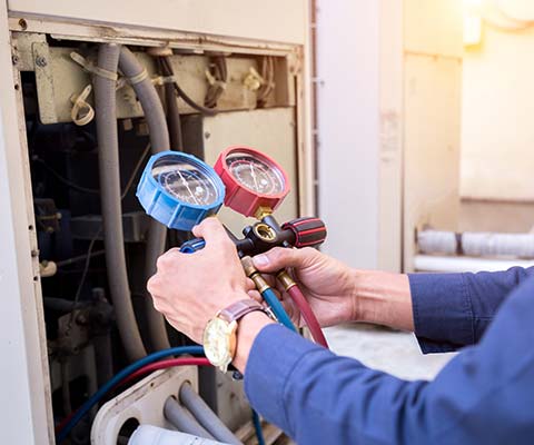 Technician Checking the Air Conditioner | Derry, NH | Derry Plumbing & Heating