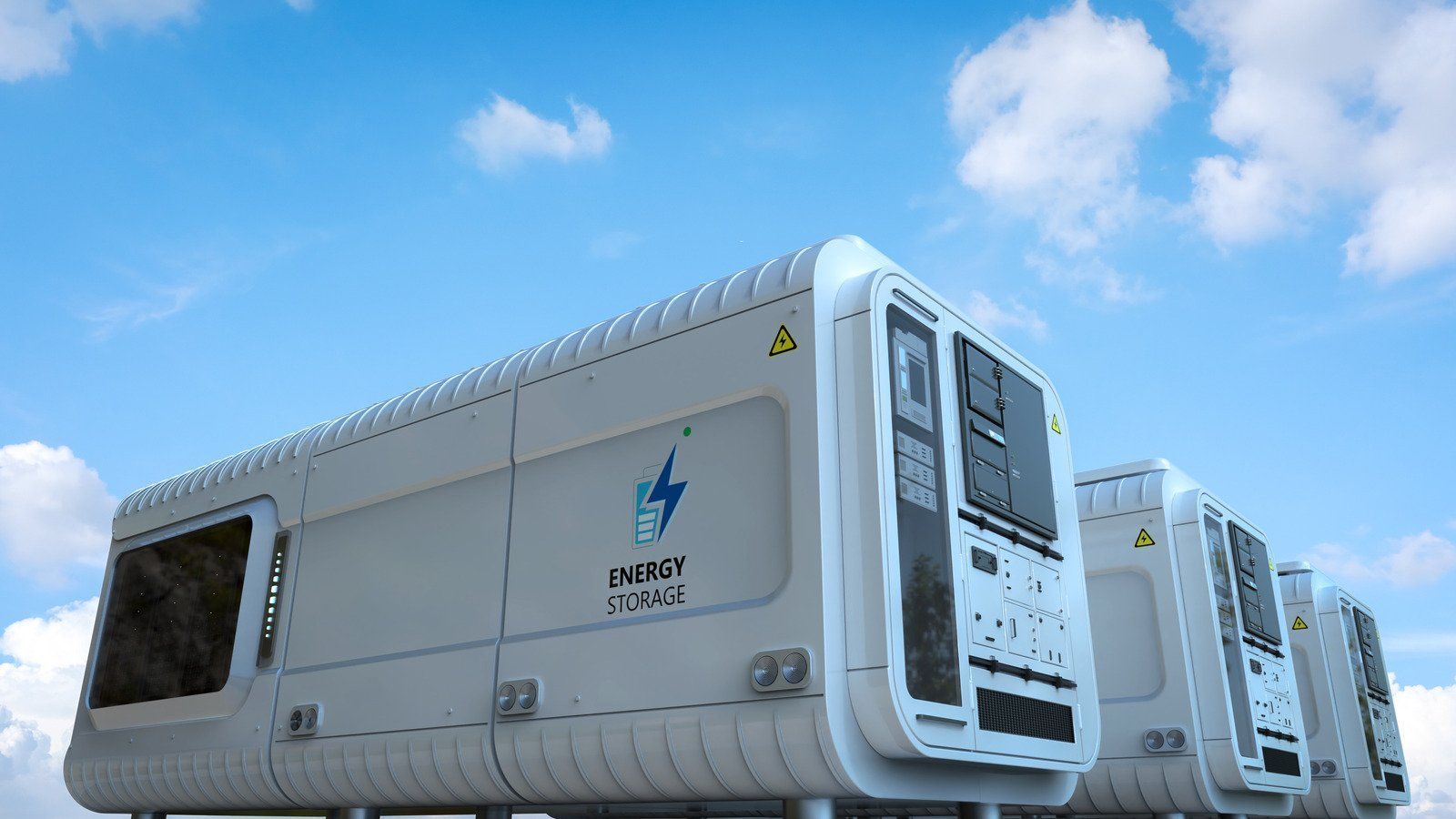 White energy storage containers under a blue sky with clouds; 
