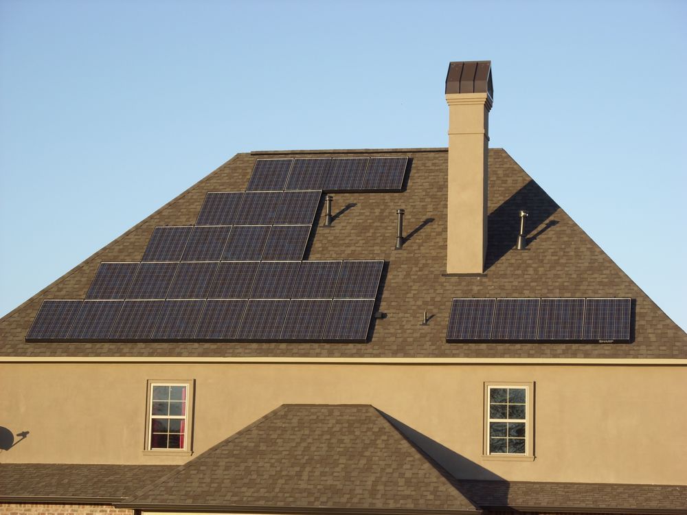 A house with a chimney and solar panels on the roof