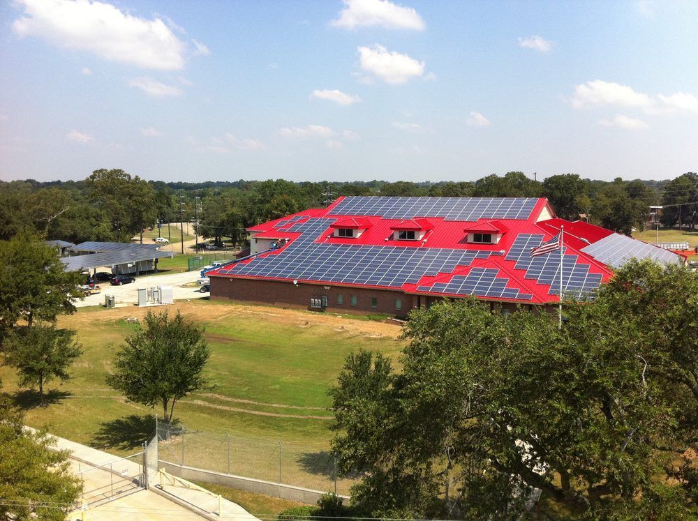 A large red building with solar panels on the roof
