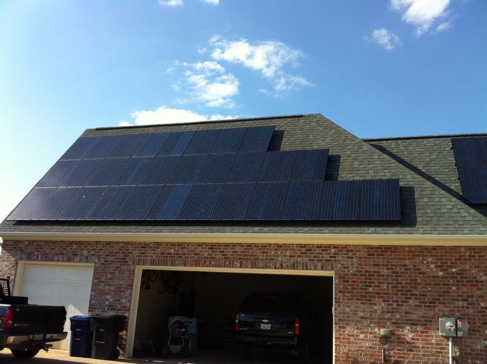 A brick house with solar panels on the roof