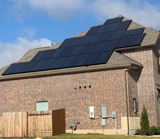 A brick house with solar panels on the roof