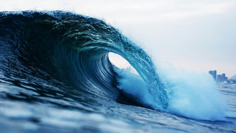 A large wave in the ocean is breaking on the shore surfing the vast info on google