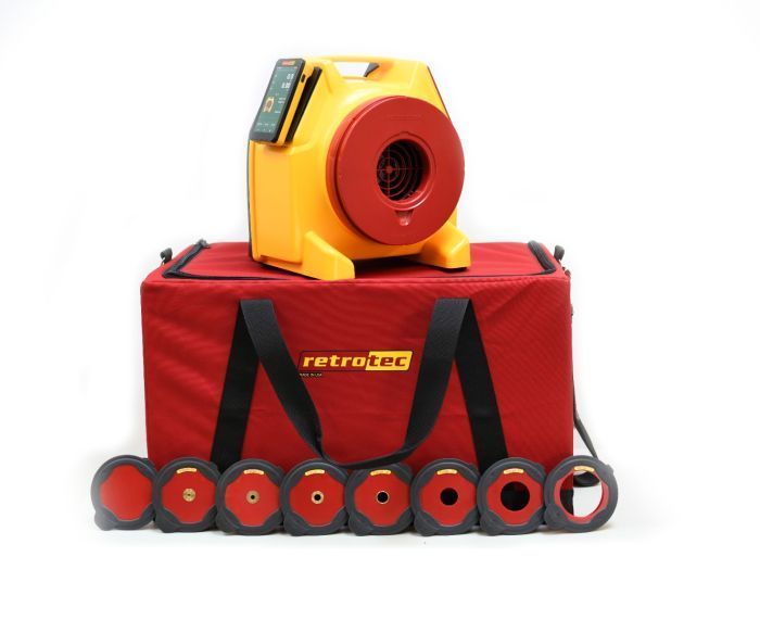 A red retrotec bag with a yellow device on top of it