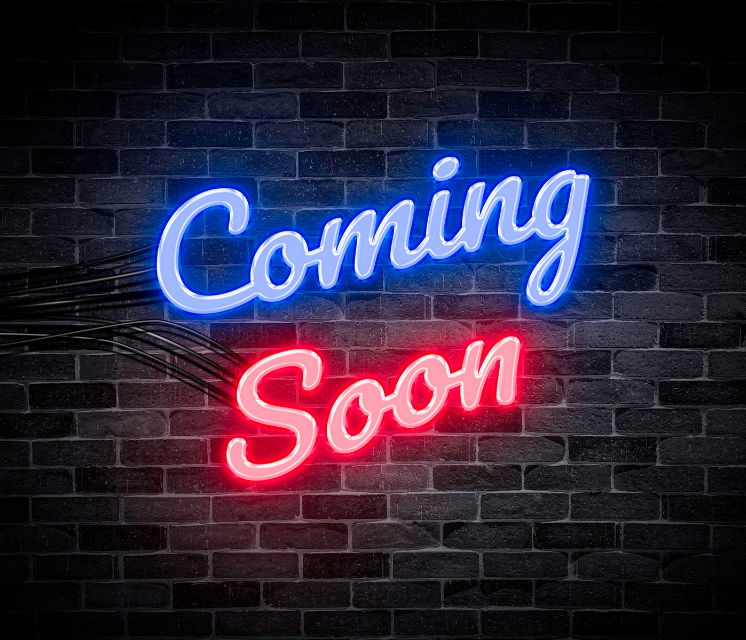 A neon sign that says coming soon on a brick wall