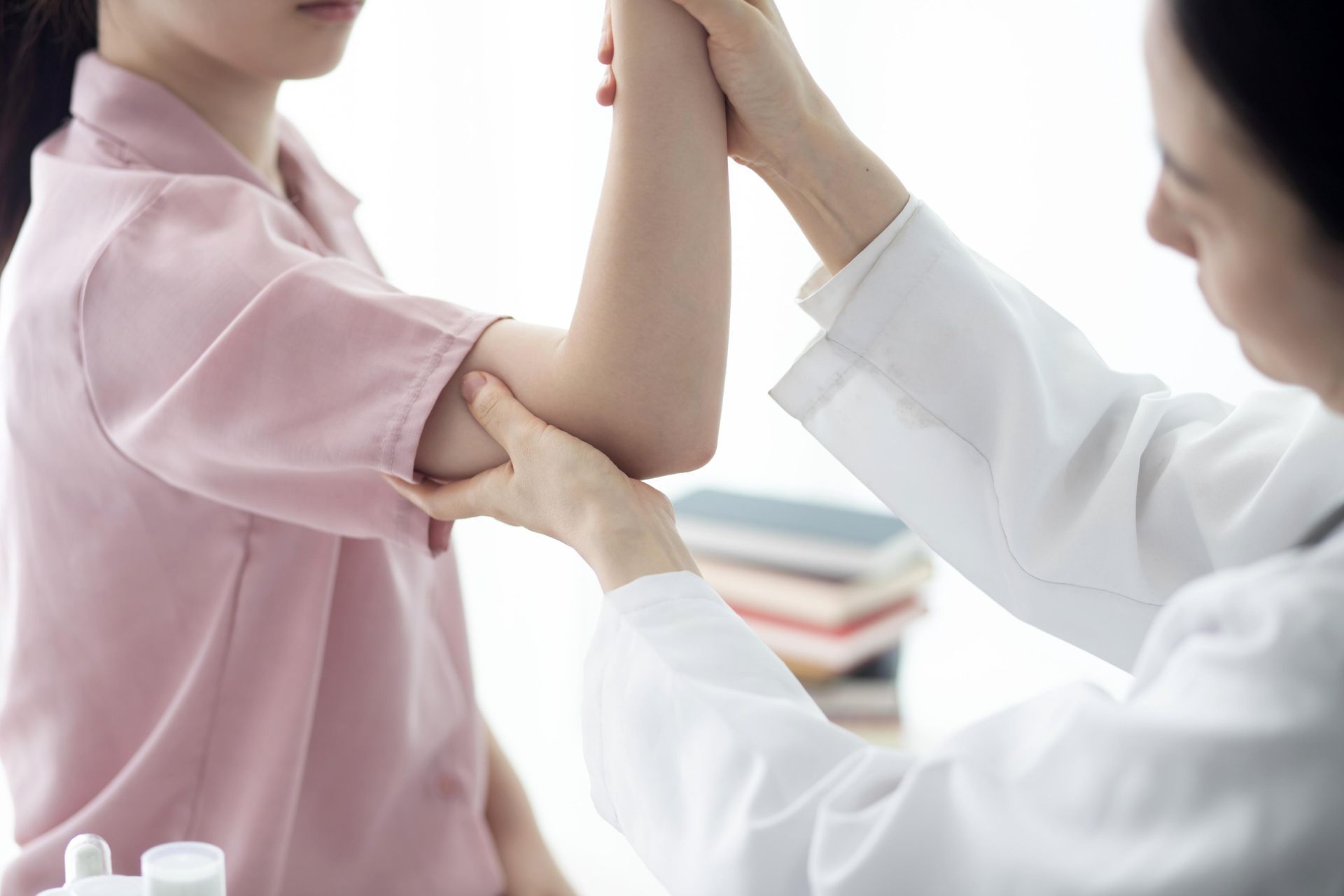 Doctor examining a patient’s arm in a clinic setting