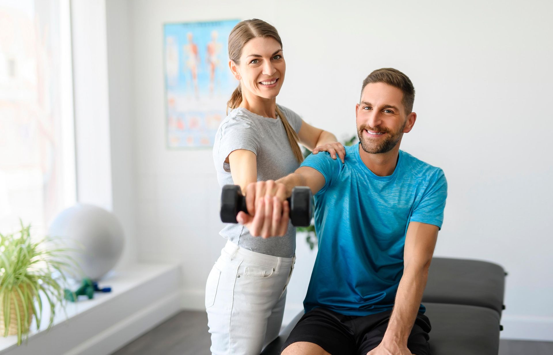 Two people using a cable machine in a bright gym, smiling during a fitness session