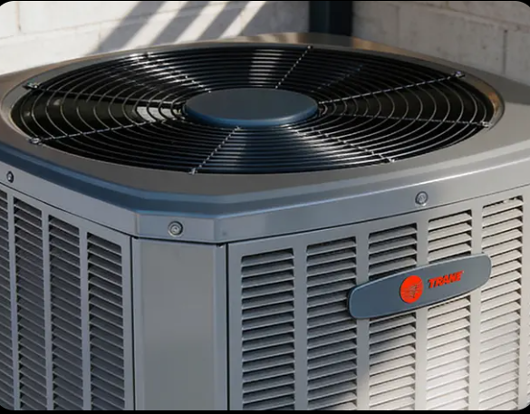 Gray Trane outdoor air conditioner unit with a black top fan and side vents