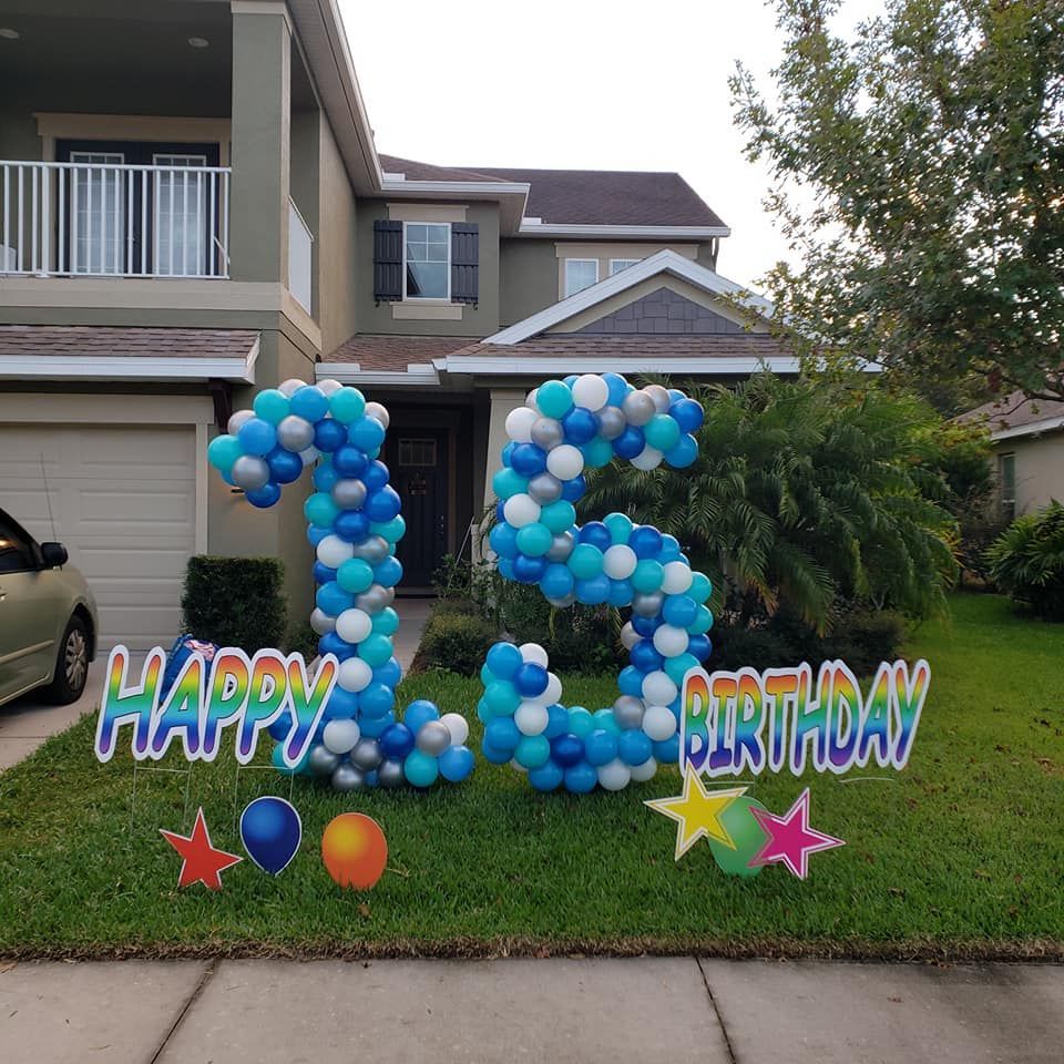 The number 15 is made out of blue and white balloons