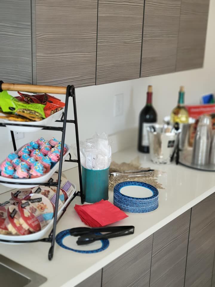 A kitchen counter with plates of food and a bottle of wine
