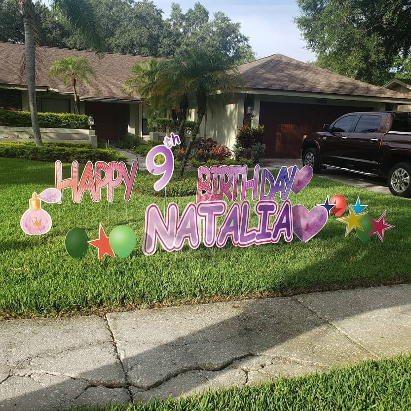A happy 9th birthday sign for natalia is in front of a house.