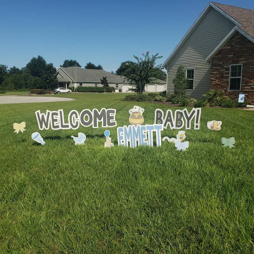 A welcome baby sign in front of a house