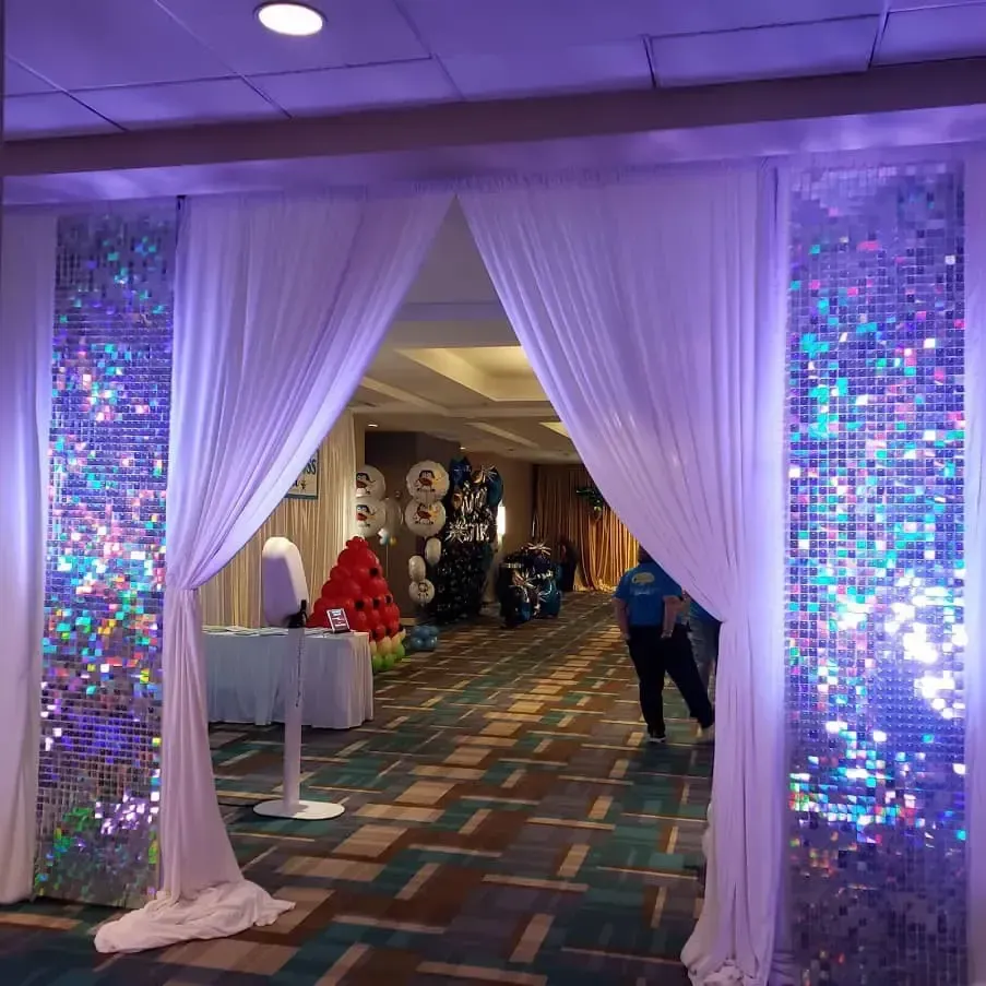 A hallway with purple lights and white curtains