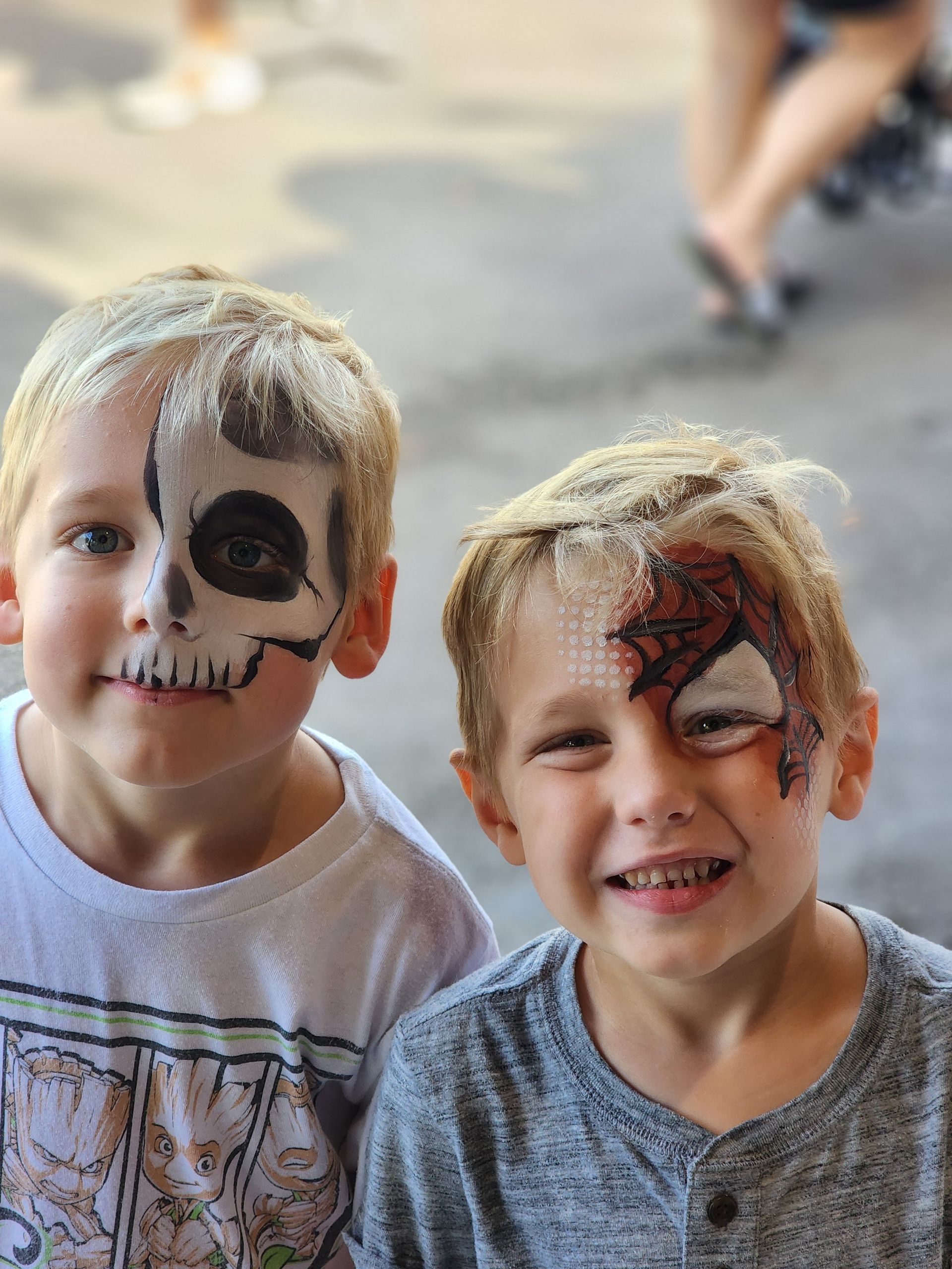 Two young boys with face paint on their faces.