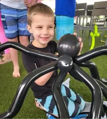 A young boy with a spider balloon