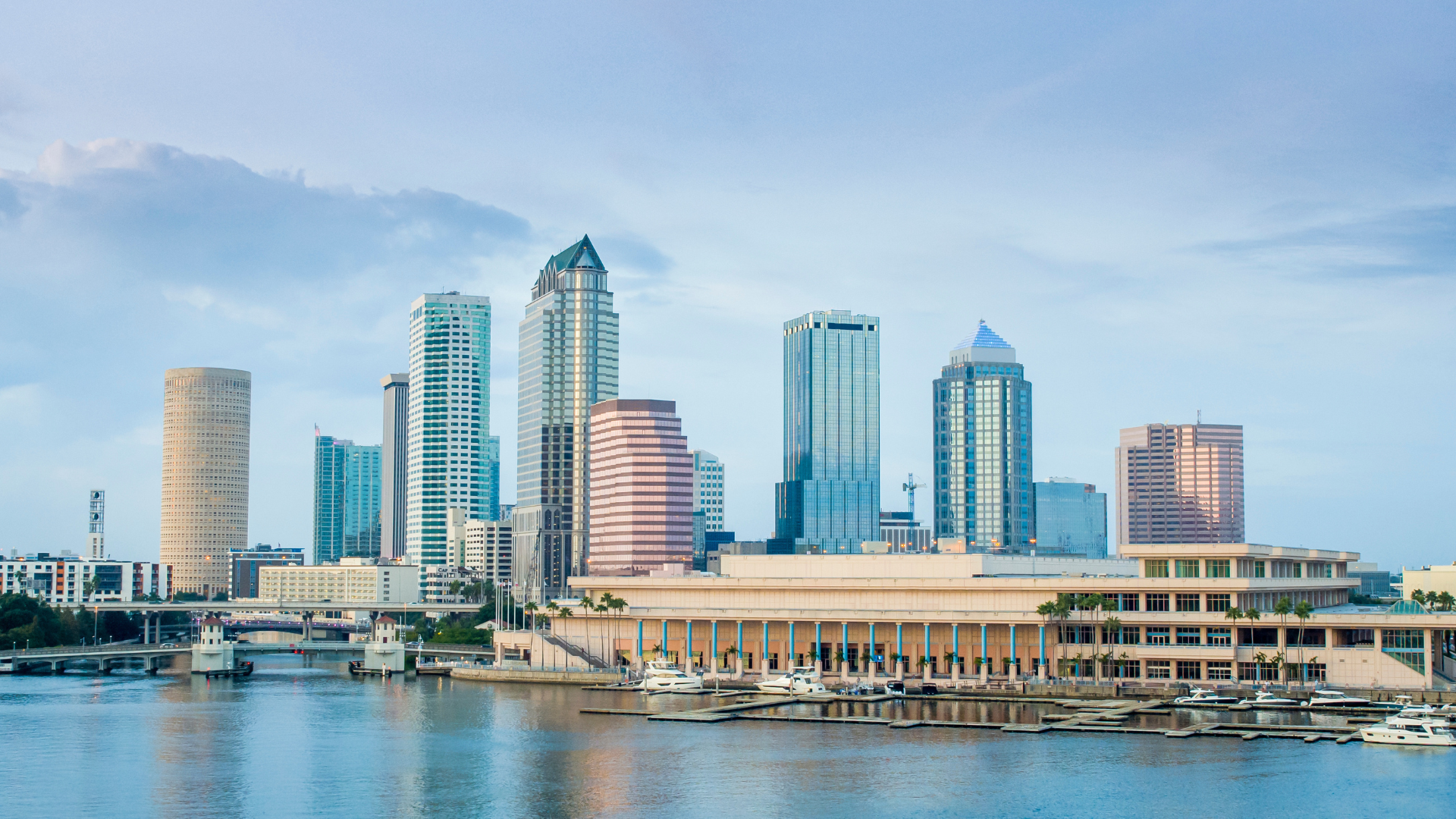A city skyline with a body of water in the foreground.