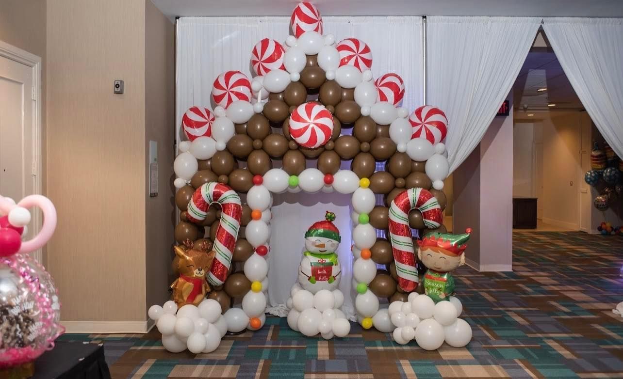 A room decorated with balloons in the shape of a gingerbread house.