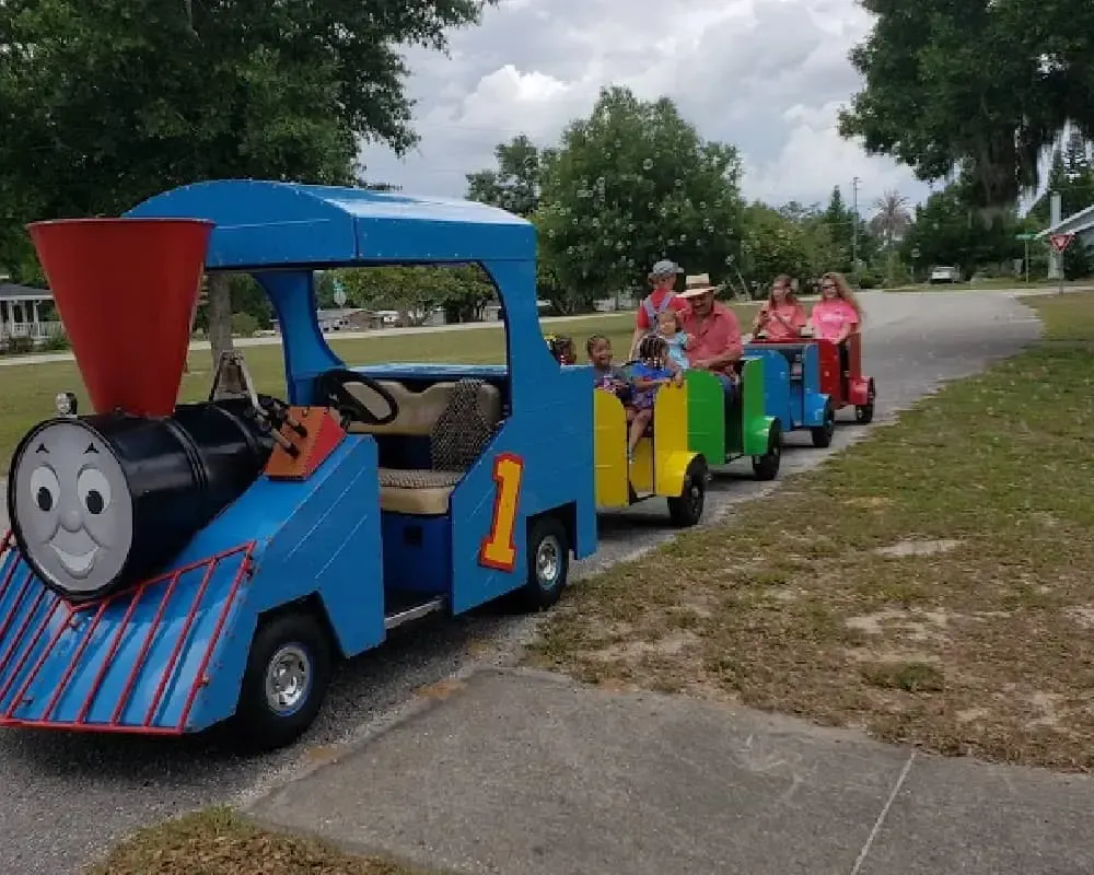 A group of people are riding on a train that has the number 1 on it