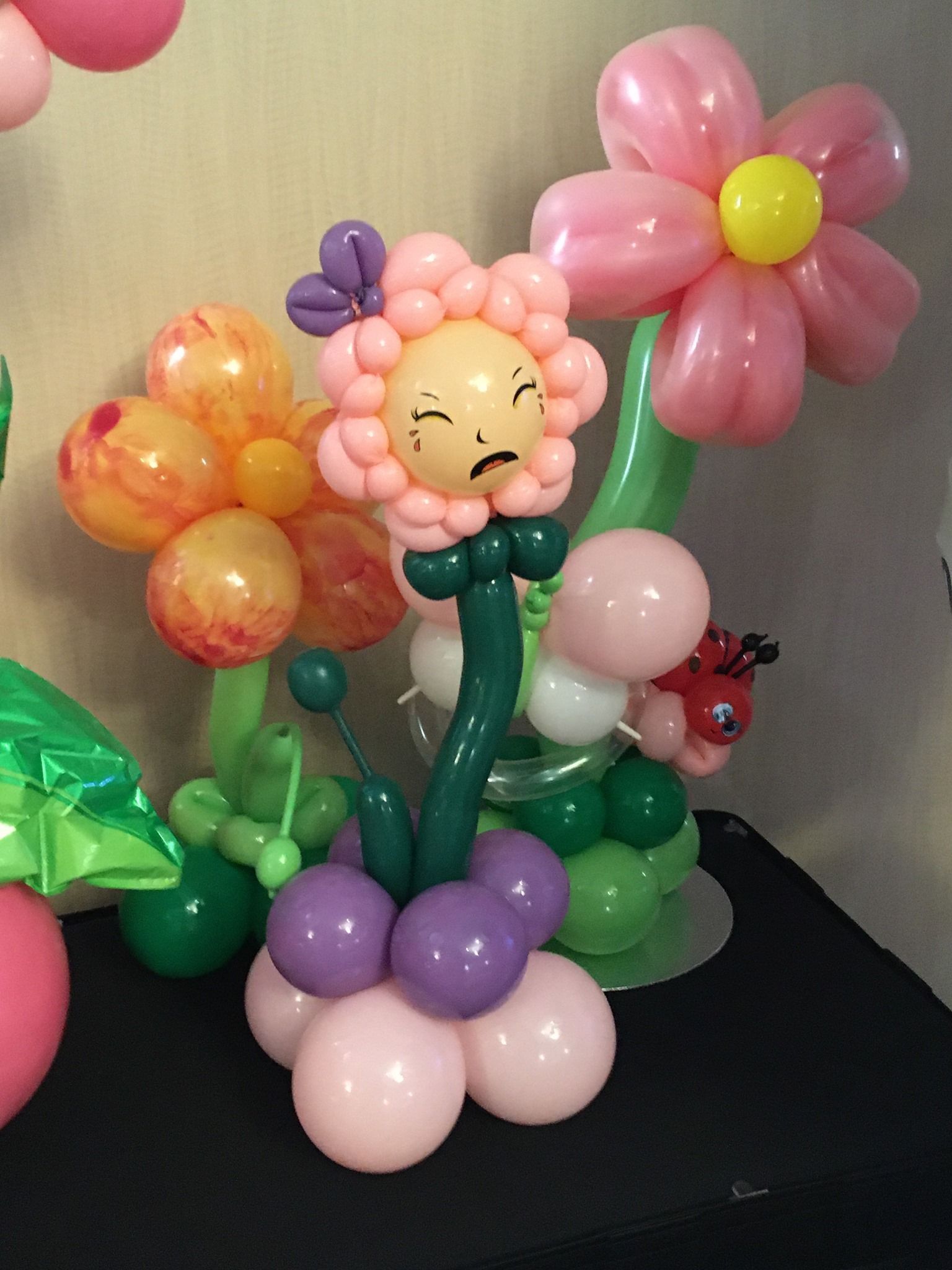 A bunch of balloons shaped like flowers are sitting on a table