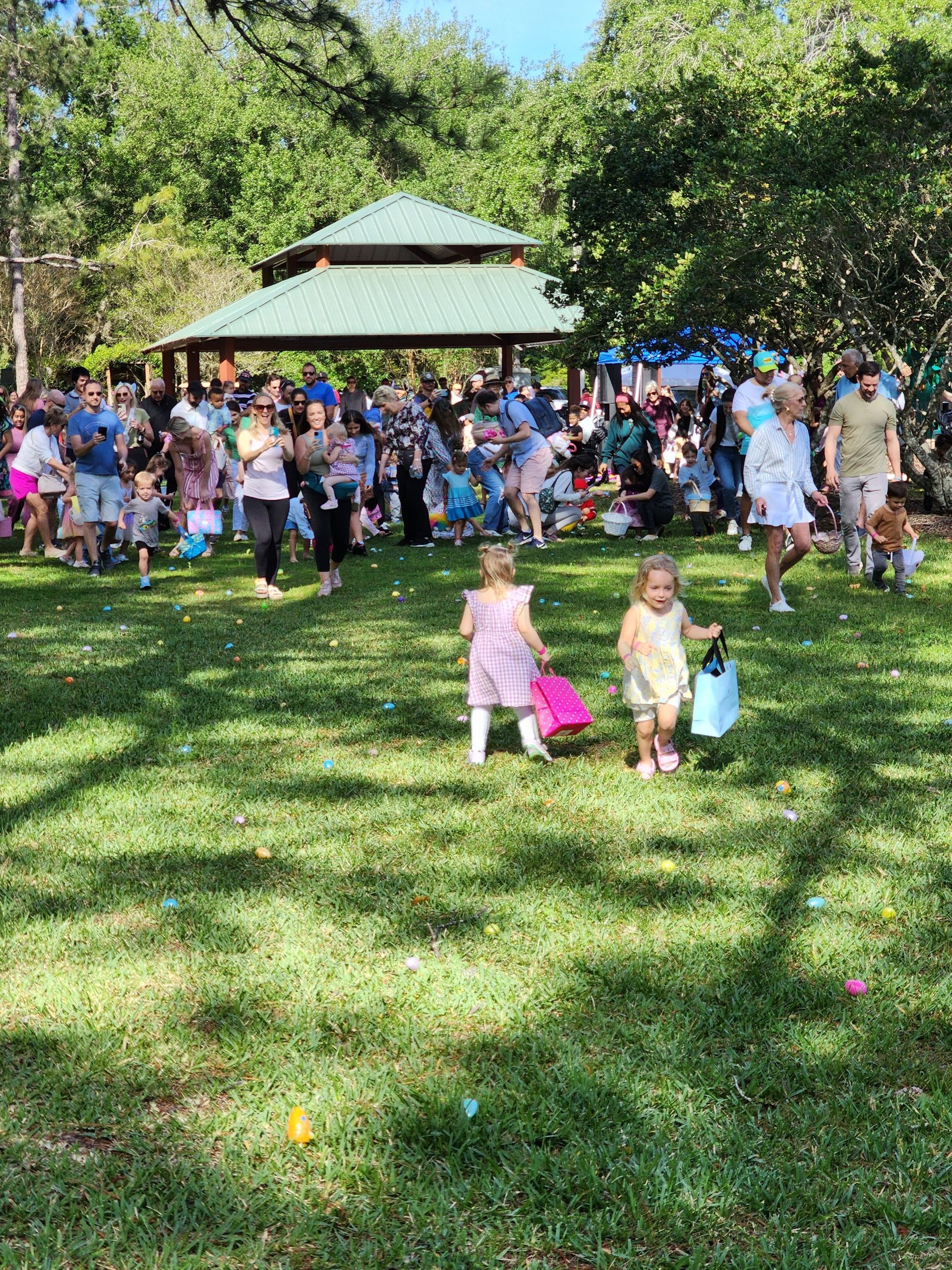 A group of people are gathered in a park.