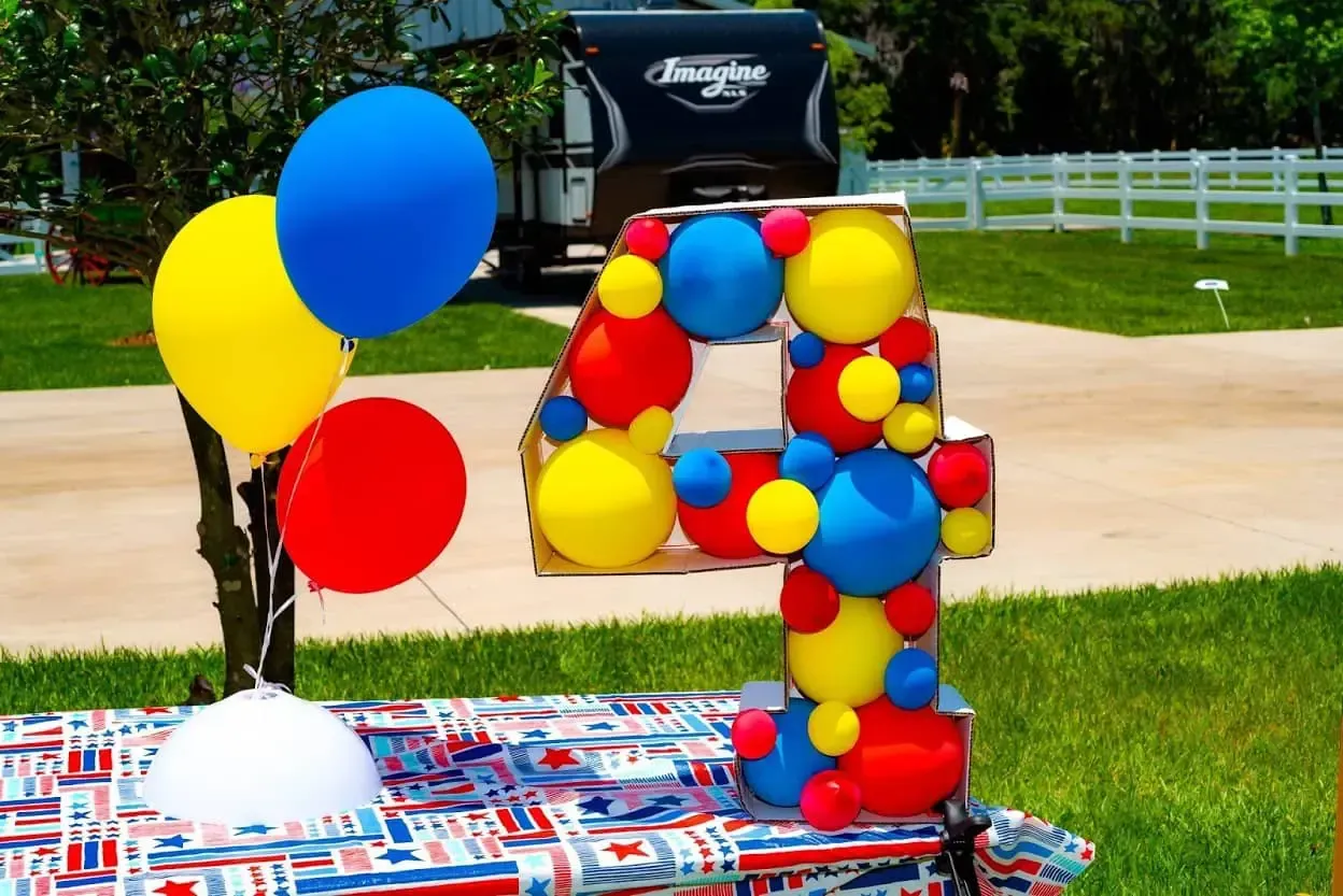 A number four made out of balloons on a table