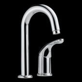 A close up of a chrome faucet on a black background.