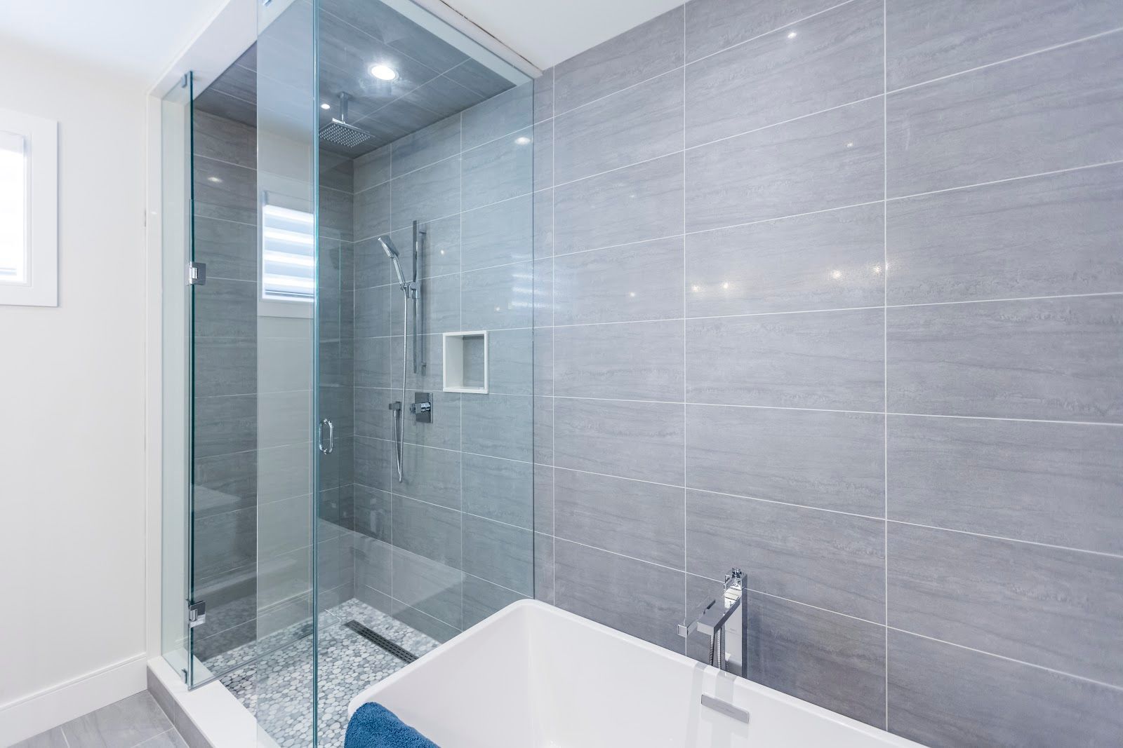 A bathroom with a bathtub and a walk in shower.