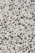 A close up of a white and black terrazzo counter top.