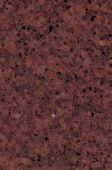A close up of a red granite counter top.