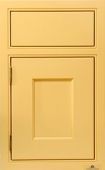 A close up of a yellow cabinet door with a drawer.