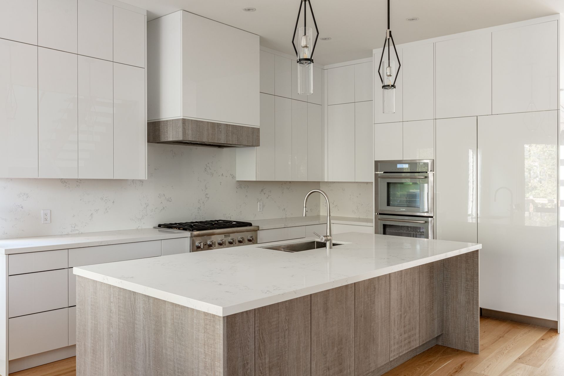 A modern kitchen with stainless steel appliances and wooden counter tops.