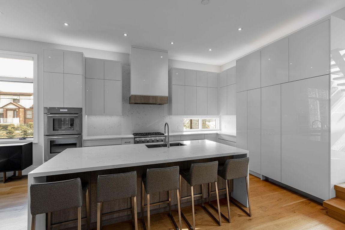 A kitchen with black cabinets and a stove top oven.