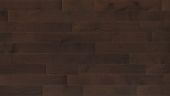 A close up of a brown wooden floor with a brick wall in the background.