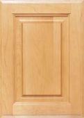 A close up of a wooden cabinet door on a white surface.