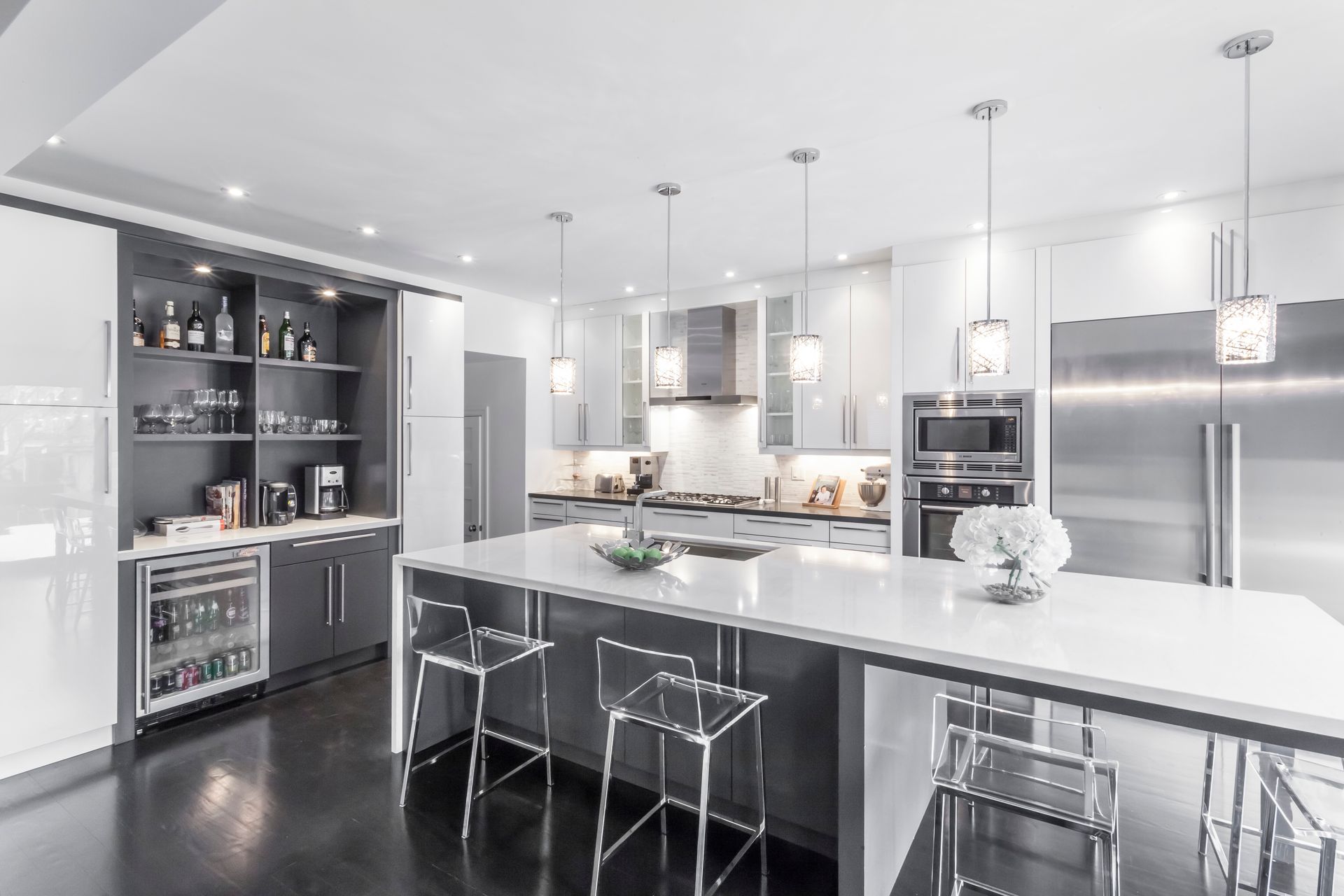 A kitchen with stainless steel appliances and a large island.