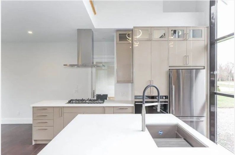 A kitchen with stainless steel appliances and white cabinets