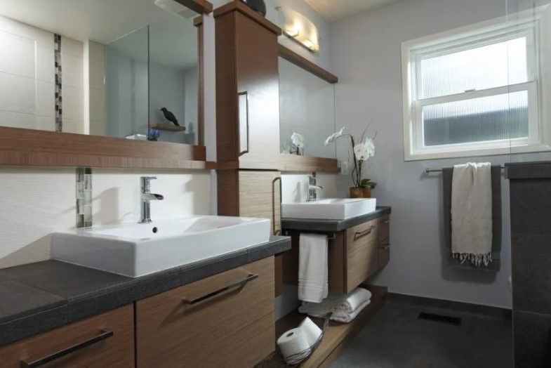 A bathroom with two sinks and a window