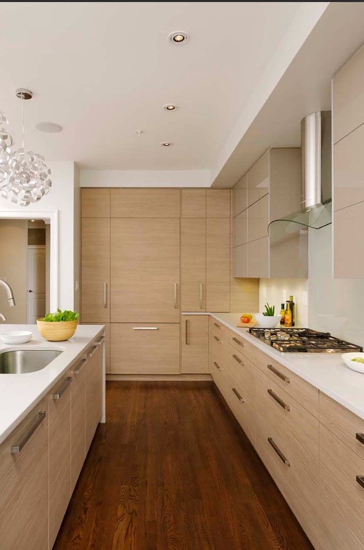 A kitchen with wooden cabinets and white counter tops