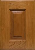 A close up of a wooden cabinet door with a window.
