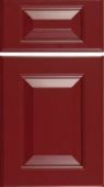 A close up of a red cabinet door on a white background.