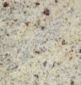 A close up of a white granite counter top with brown spots.