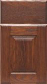 A close up of a wooden cabinet door with a drawer.