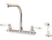 A kitchen sink faucet with white handles and a sprayer.