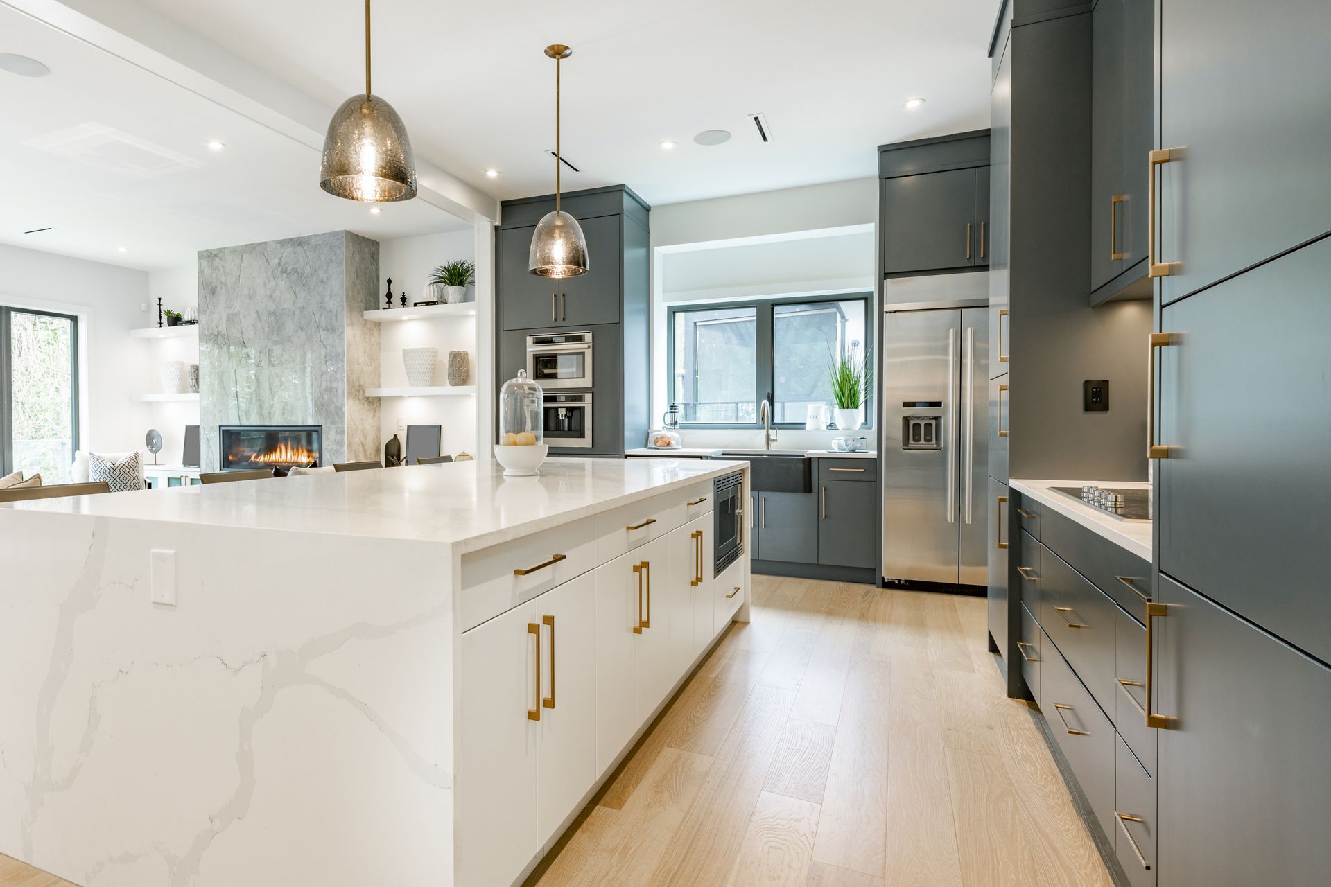 A kitchen with a large island and stainless steel appliances.