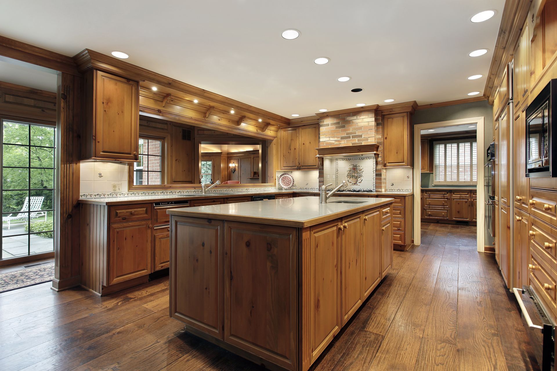 A kitchen with black cabinets and white counter tops.