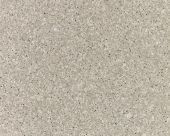 A close up of a white carpet with a grainy texture.