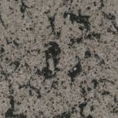 A close up of a granite counter top with black spots.