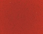 A close up of a red surface with a grainy texture.