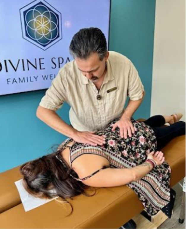 A man is giving a woman a massage at divine spa