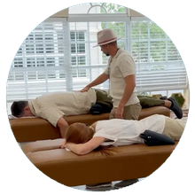 A man in a hat is giving a woman a massage.